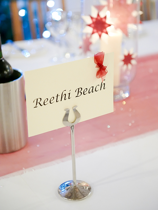 Wedding place names had a little red bow on to fit in with the winter wedding theme