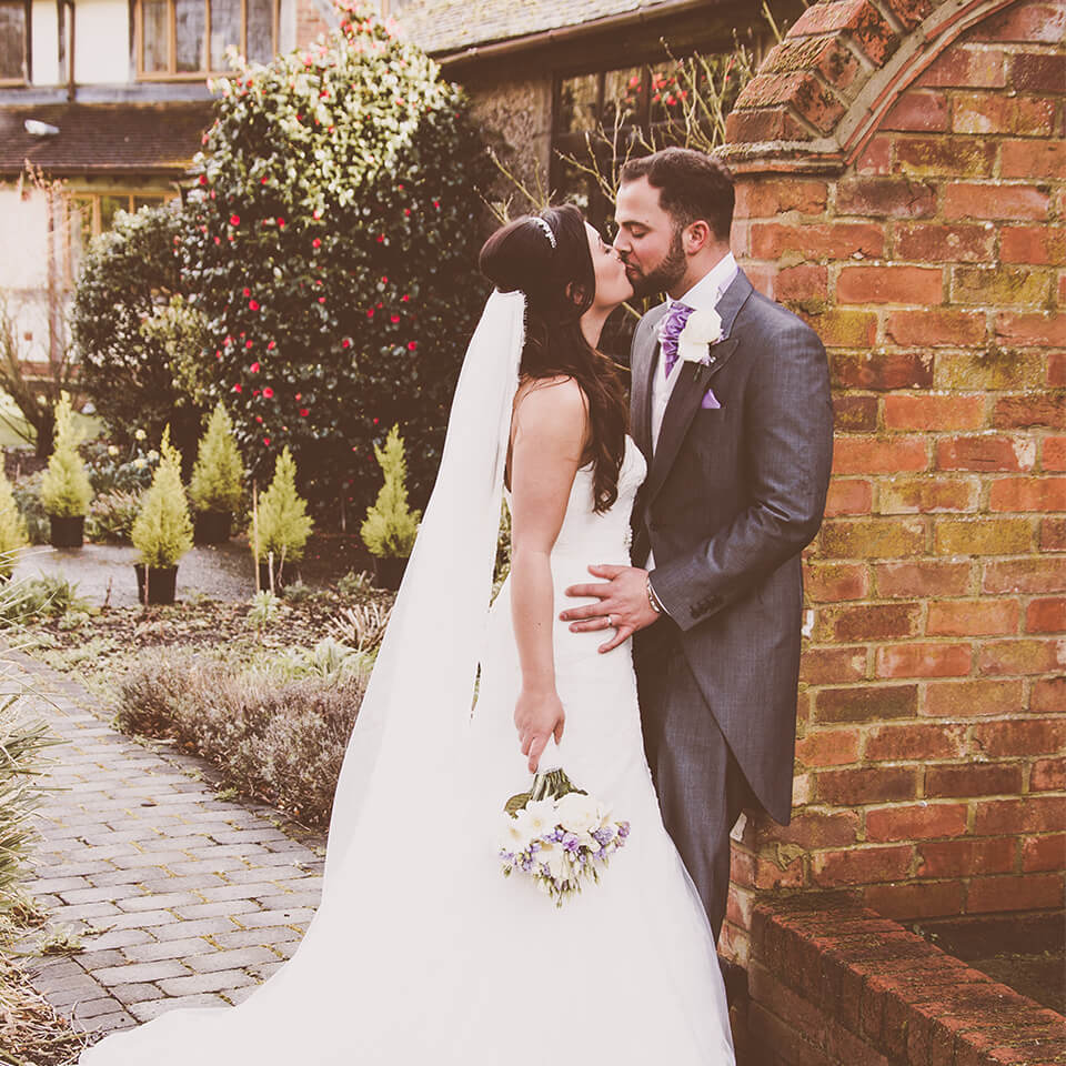 The bride and groom share a kiss during their autumn wedding day in Hampshire