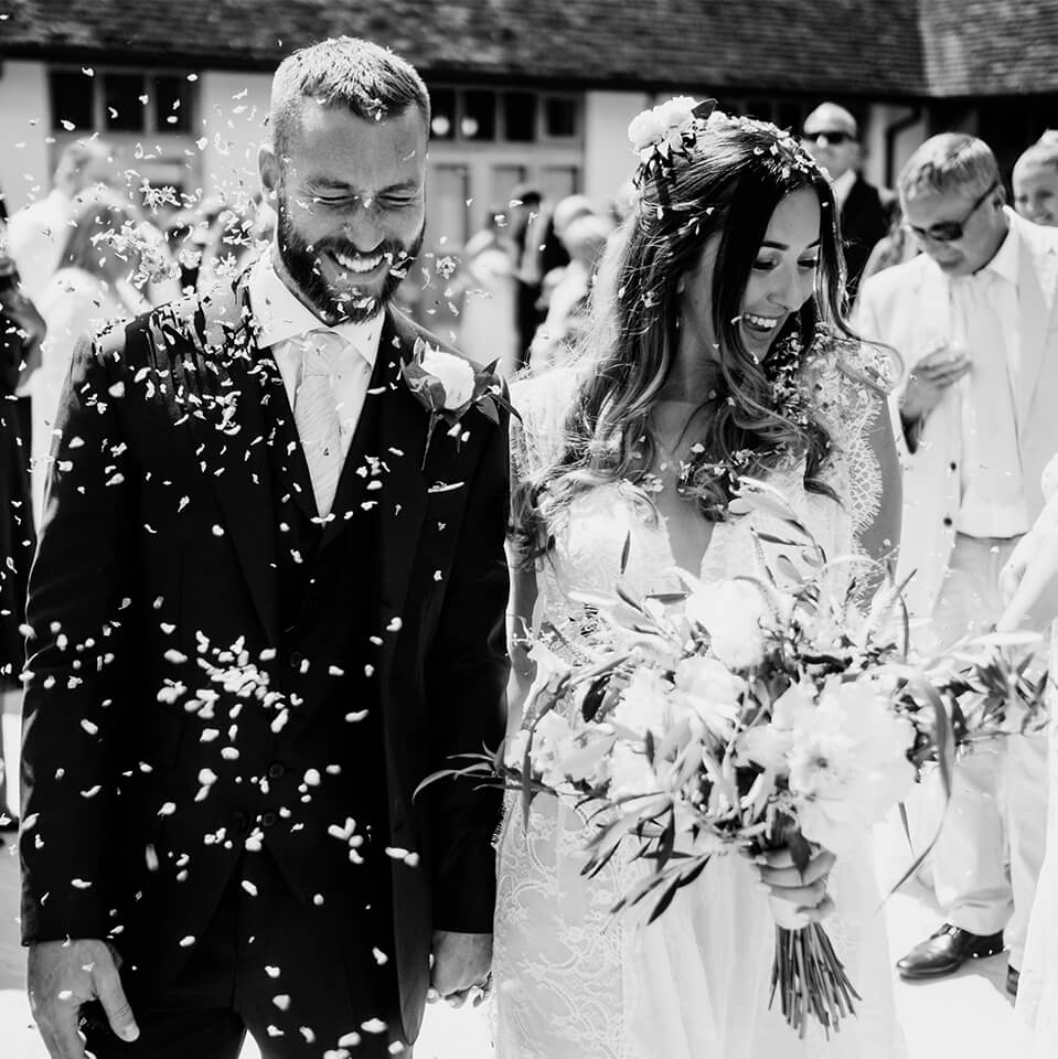 The bride and groom celebrate with confetti before the drinks reception