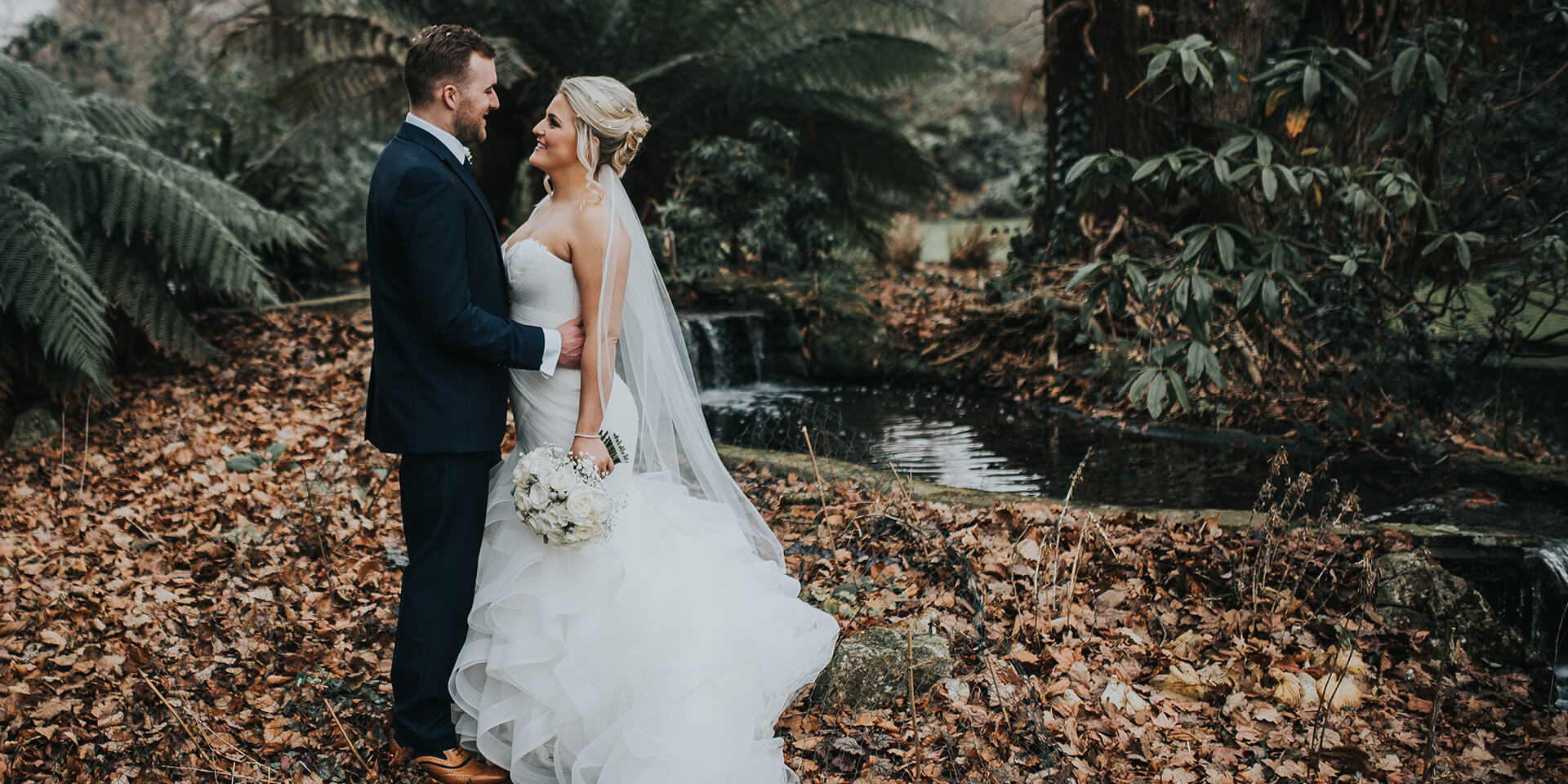 The bride and groom took a moment in the winter leaves at one of Hampshire's finest wedding venues