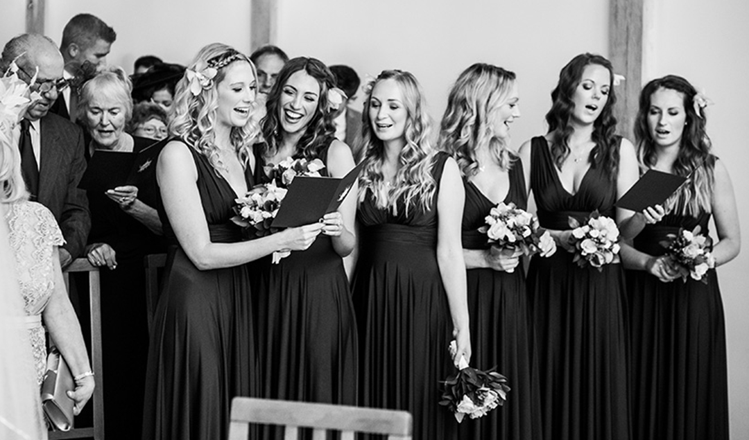 The bridesmaids sang along during the wedding ceremony at Rivervale Barn in Hampshire