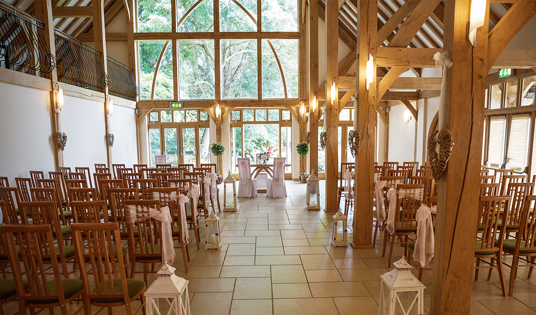 The ceremony barn at Rivervale Barn wedding venue was dressed elegantly ready for Nikki and Maurice’s wedding