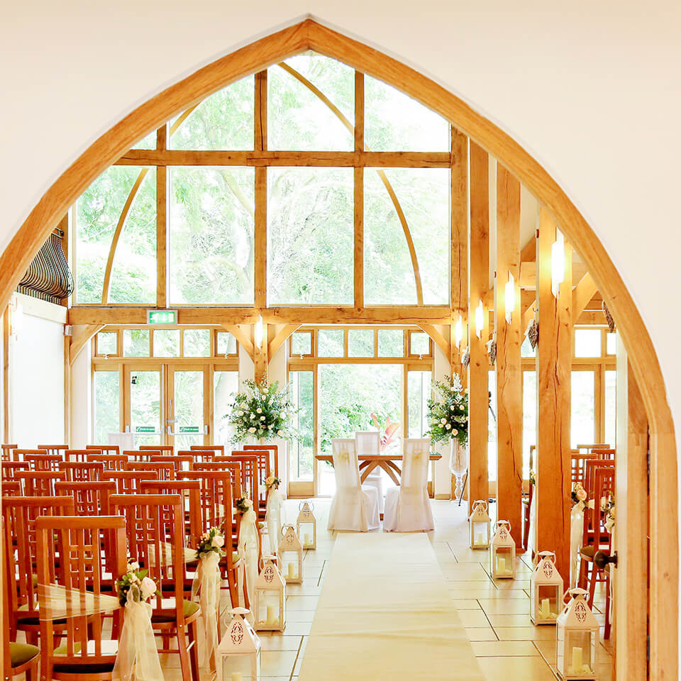 The sun shining through the windows of the Ceremony Barn, the perfect summer wedding venue