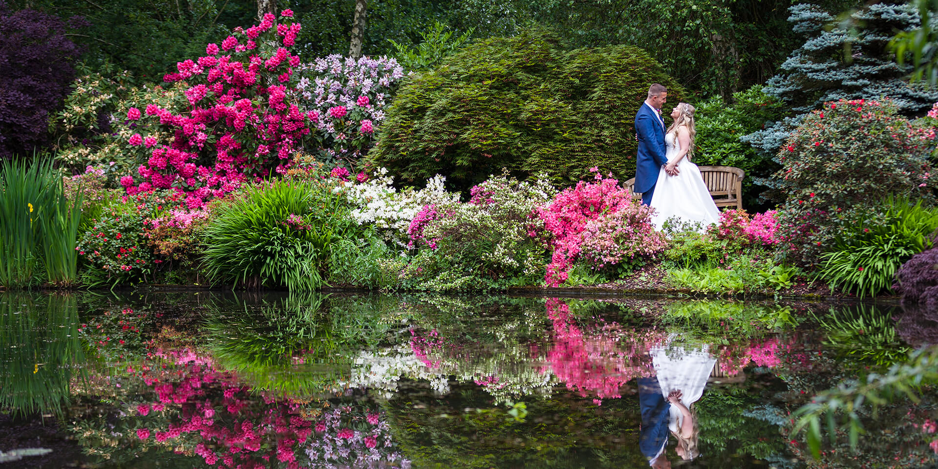 The pink flowers made the perfect setting for a photo during this spring wedding at Rivervale Barn