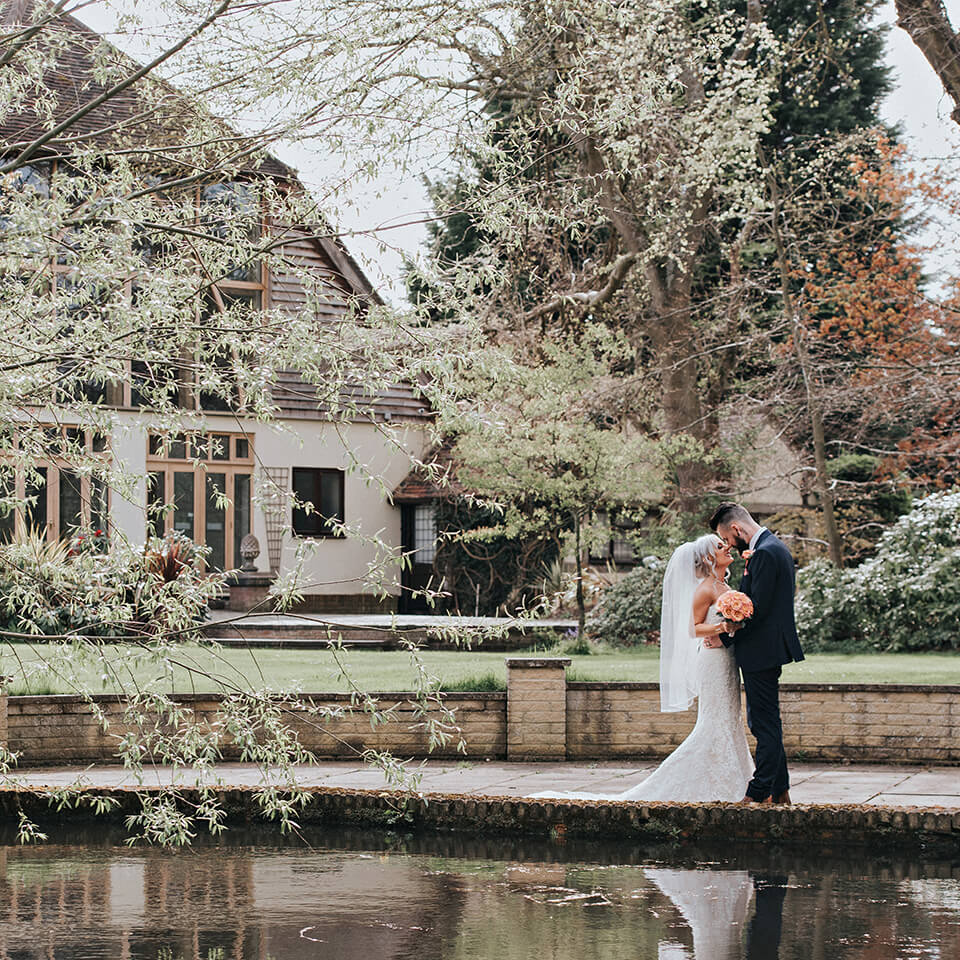 The couple enjoyed the gardens during their frosty spring wedding at one of Hampshire's most beautiful wedding venues