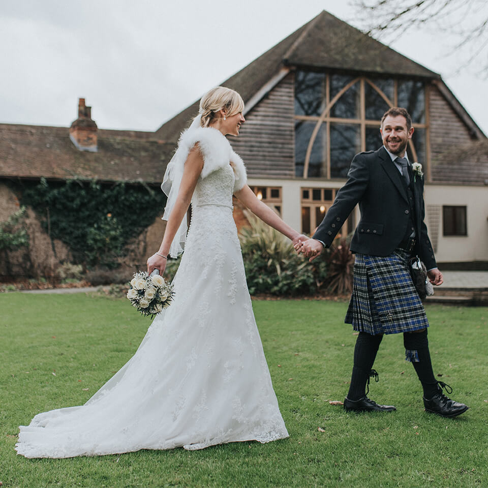 The bride and groom explored Rivervale Barn's gardens during their wedding in winter