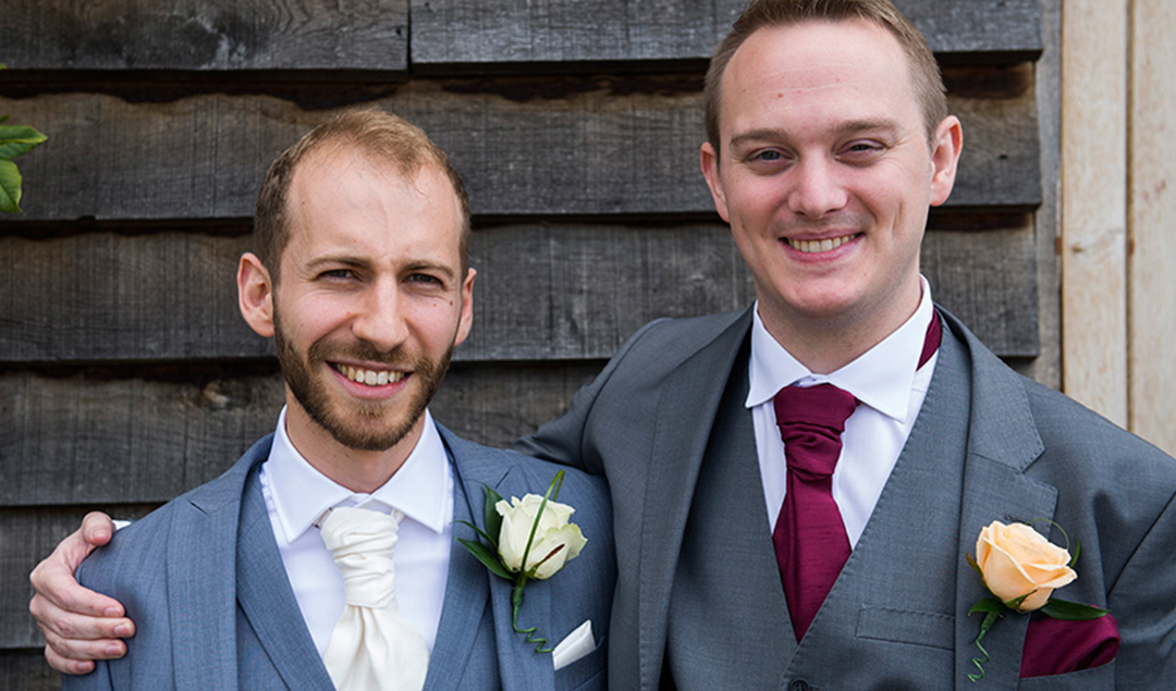 The groom and his best man pose happily outside of this exquisite Hampshire wedding venue