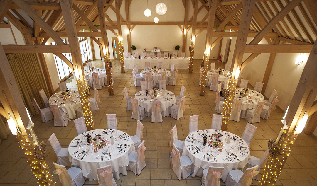 The reception barn was lit up with spiraling fairy lights and pink bows decorating the chairs