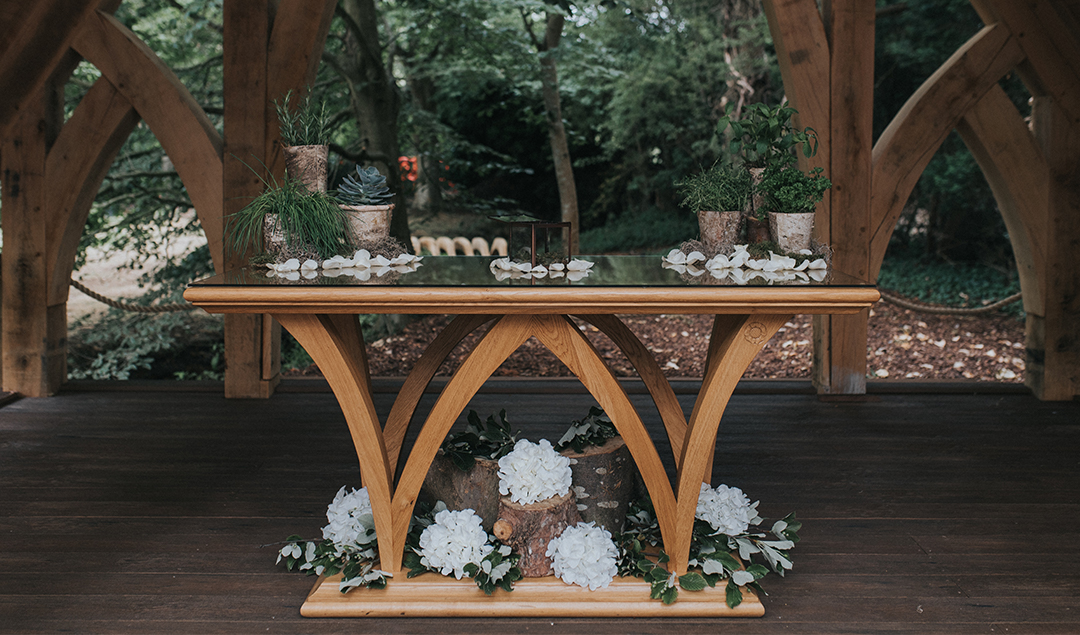 The Spinney prepped with a gorgeous wooden table decorated in simple white flowers