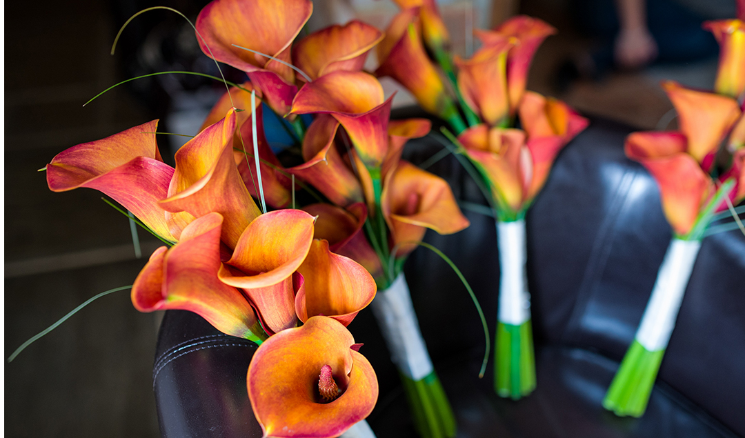 The bride chose delightful orange lily bouquets for herself and her bridesmaids to match the atmosphere of this stunning wedding venue in Hampshire