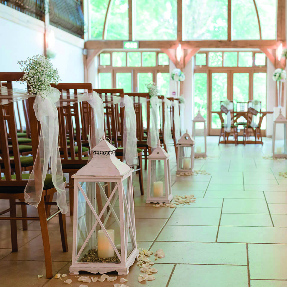 Lanterns and flower petals were scattered along the aisle ready for a spring wedding day
