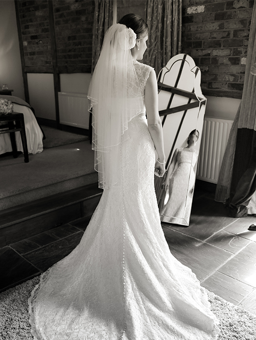 The bride posing in her gorgeous wedding dress in this Hampshire venue’s honeymoon cottage