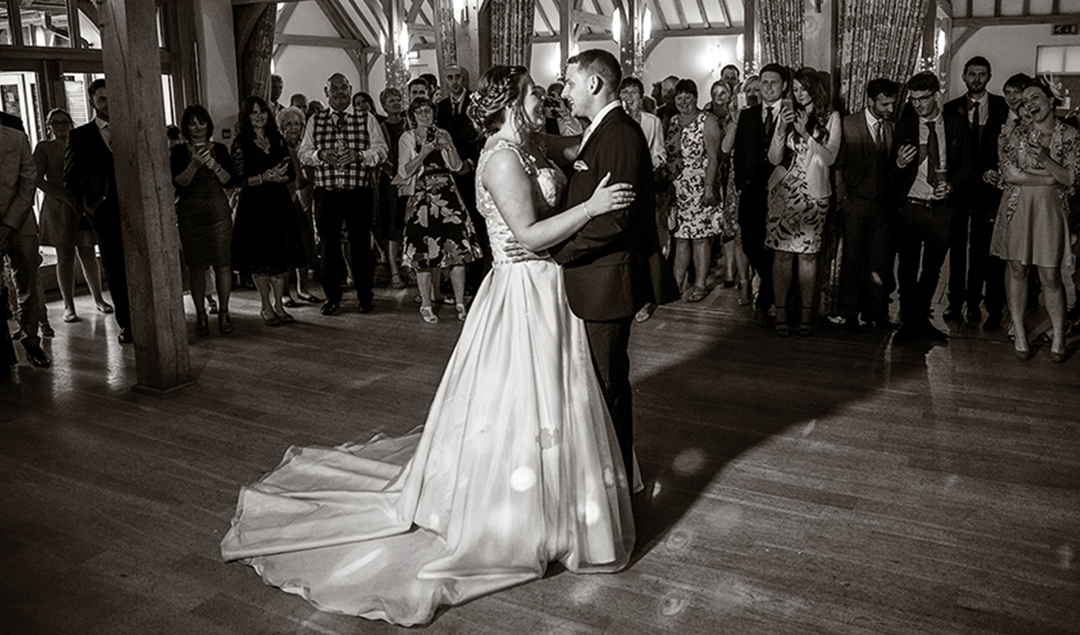 Newlyweds come together for their first dance at this stunning barn wedding venue in Hampshire