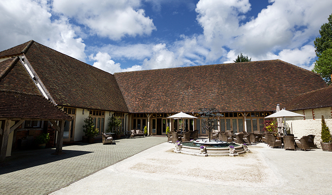The stunning courtyard at this wedding venue in Hampshire is the perfect place for guests to relax at a country wedding