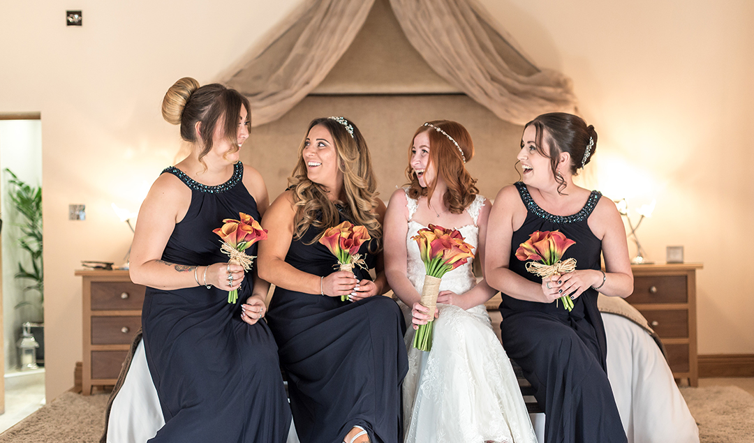 The bridesmaids wore gorgeous dark blue dresses to complement their autumnal bouquets