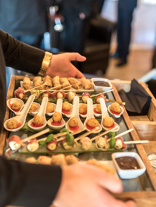 A platter of canapes being served to guests during the drinks reception including duck spring rolls
