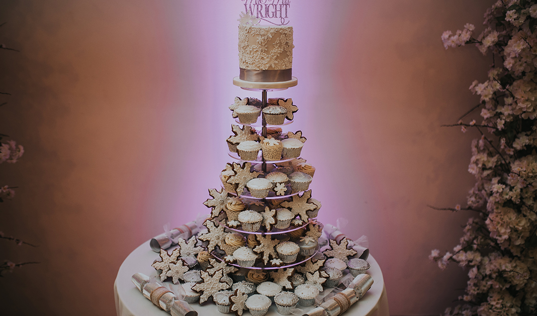 The bride and groom had a tower of cupcakes leading up to their wedding cake