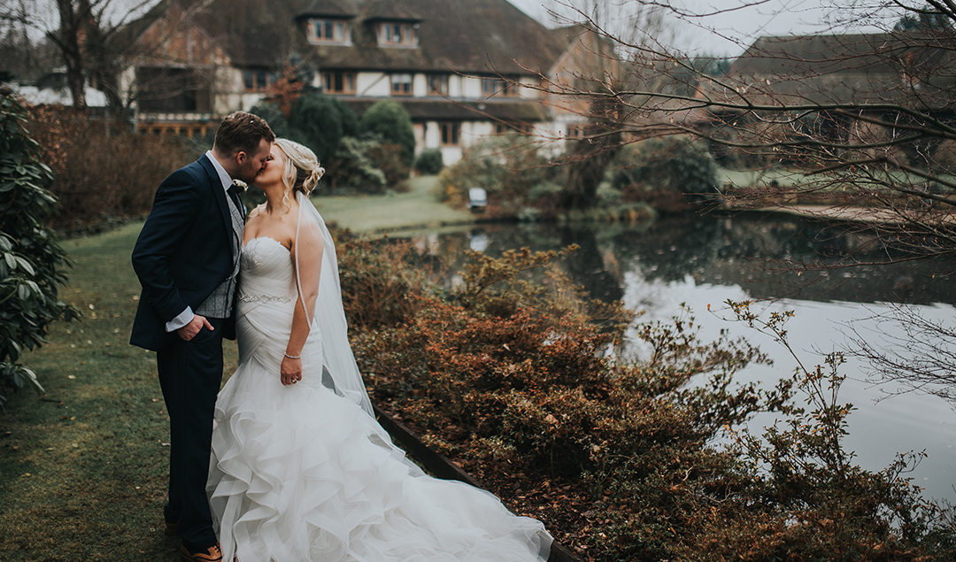 The bride and groom shared a kiss in the beautiful gardens of this Hampshire wedding venue