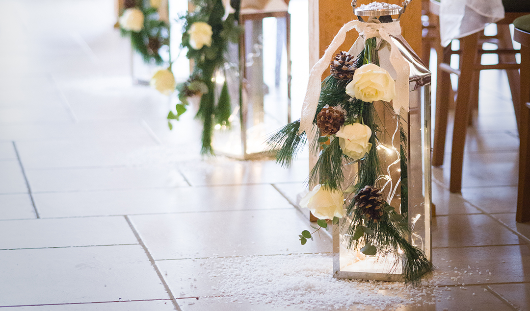 Beautifully dressed lanterns with white roses make the perfect addition to any winter wedding