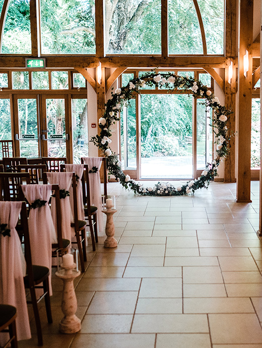 a wedding arch used as the focal point at a ceremony at this stunning Hampshire barn wedding venue