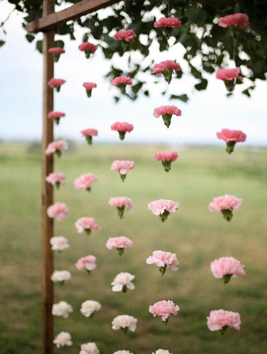 Hanging flowers make the perfect backdrop to any wedding ceremony or photobooth