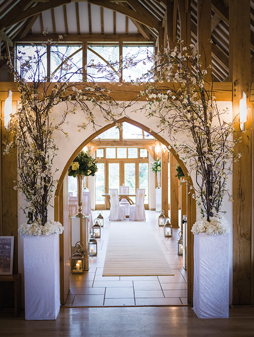 These tall stand create an archway made out of delicate blossom trees