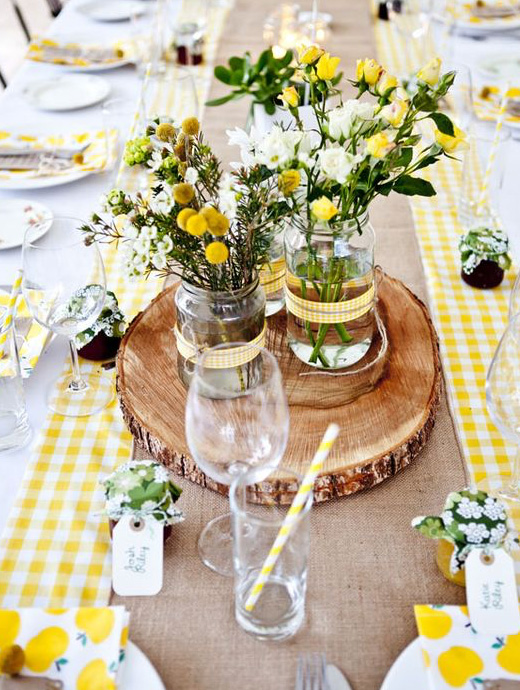 a wedding breakfast table set up with sunshine yellow décor and flowers