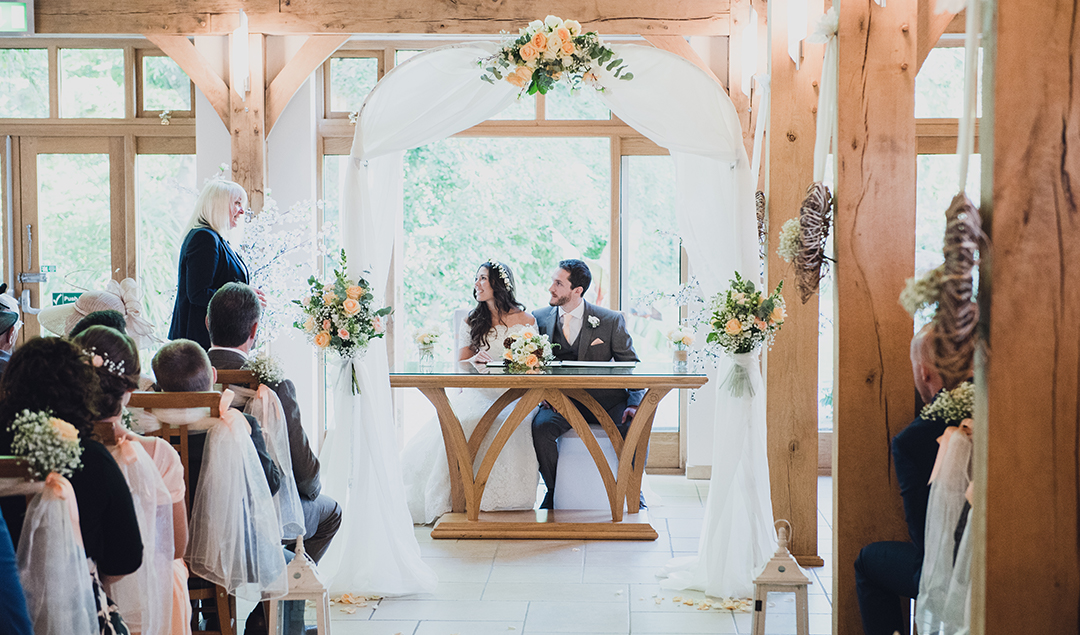 the bride and groom enjoying their wedding ceremony in this beautiful Hampshire venue
