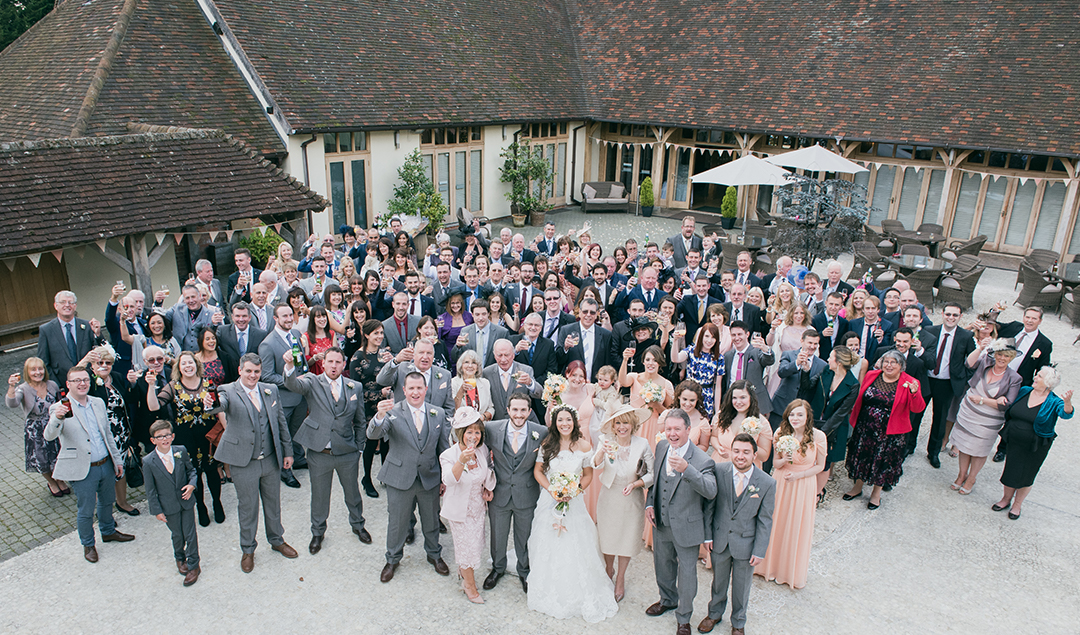 the guests gathered outside the barn venue for a group photo