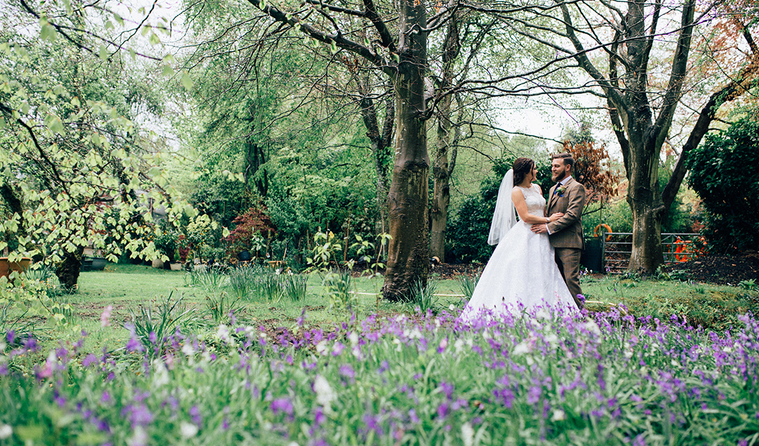 The Bride And Groom Shared A Moment In The Stunning Gardens Of