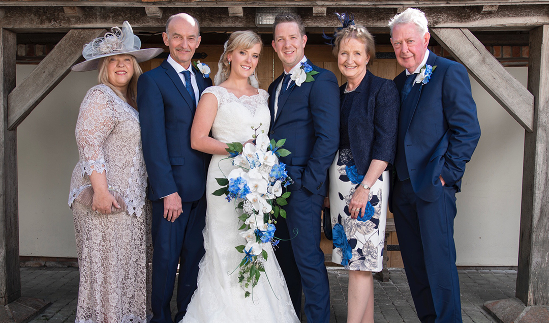 the bride and groom posed with their families for some beautiful wedding photos