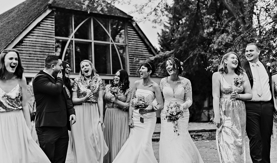 A bridal party enjoy making the most of this beautiful barn wedding venue which is exclusively theirs